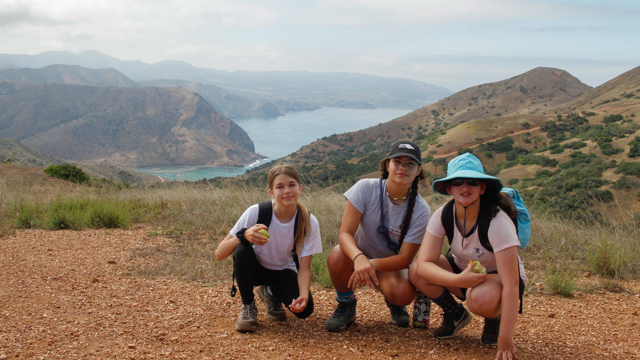 summer campers kneeling and overlooking the catalina island landscape