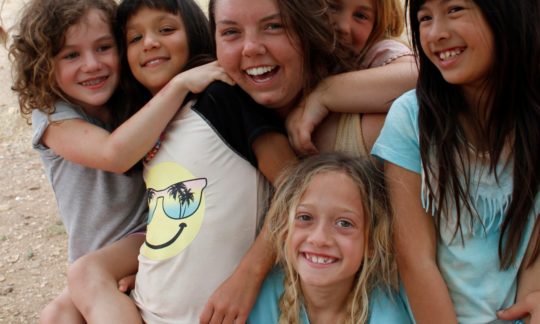 camp counselor with female campers