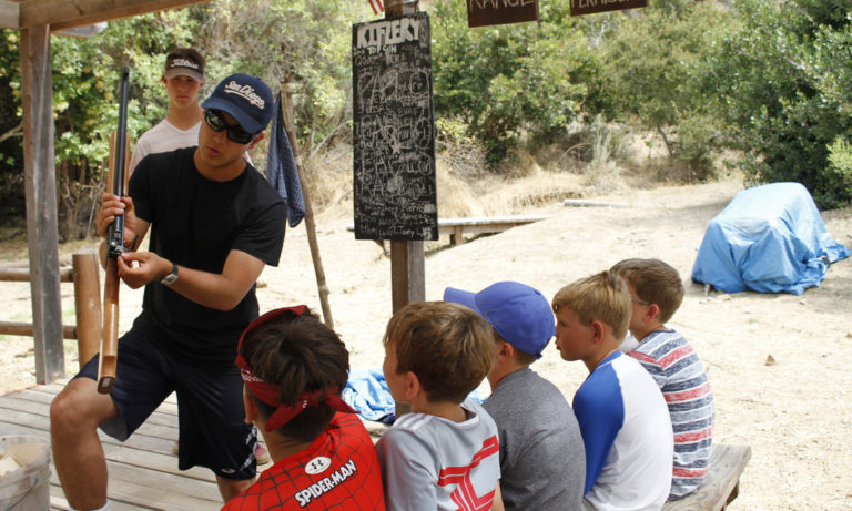 campers being instructed on proper use of the air rifles