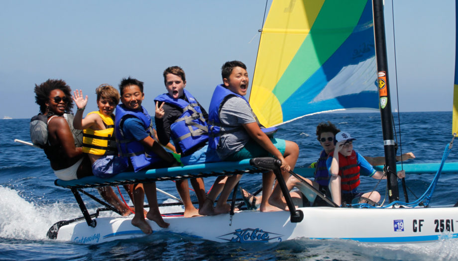campers having fun on one of the sailboats