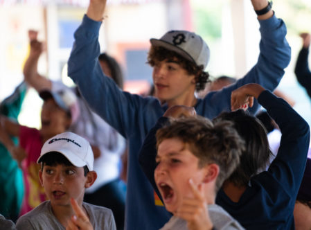 Kids celebrating an announcement at lunch